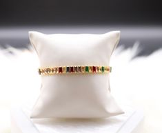 The Rainbow Colored Baguette Tennis Bracelet is a vibrant and captivating accessory adorned with a spectrum of baguette-cut gemstones, creating a stunning visual display of colors. This bracelet adds a playful and joyful touch to your ensemble, making it a lively and fashionable piece for various occasions. Elegant Rainbow Bracelets For Parties, Rainbow Baguette Cut Jewelry Gift, Adjustable Multicolor Tennis Bracelet, Elegant Multicolor Rectangular Bracelet, Luxury Elegant Rainbow Tennis Bracelet, Luxury Multicolor Multi-stone Tennis Bracelet, Multicolor Multi-stone Cubic Zirconia Tennis Bracelet, Baguette Cut, Visual Display