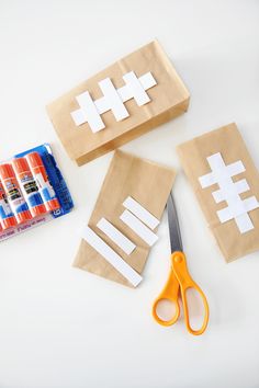 some crafting supplies are laid out on a table with scissors, glue and paper