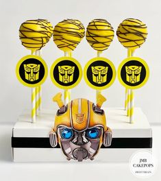 some yellow and black cake popss are in the shape of a bumble head