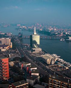 an aerial view of a city with lots of tall buildings and boats in the water