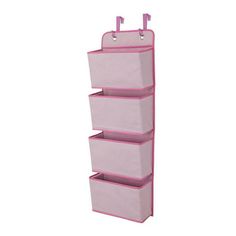 a pink hanging organizer with three bins and two hooks on the bottom, in front of a white background