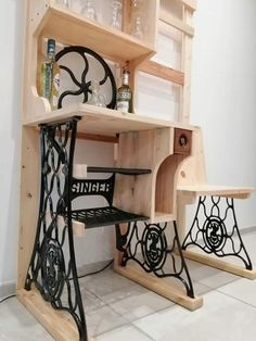 an old fashioned sewing machine turned into a desk with shelves and stools on it