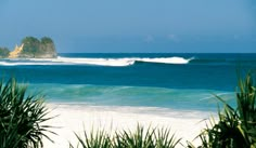 an ocean view with waves crashing on the shore