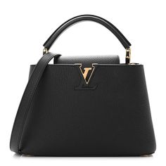 This authentic LOUIS VUITTON Taurillon Capucines BB in Black. This beautiful bag is crafted of textured leather in black. This handbag features an leather top handle, optional shoulder strap, a flap closure, and gold hardware. The top opens to a pink leather interior with a zipper pocket. Pink Leather, Beautiful Bags, Leather Interior, Leather Top, Authentic Louis Vuitton, Gold Hardware, Top Handle, Zipper Pocket, Shoulder Strap