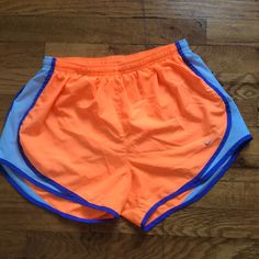 Never Worn Shorts With Adjustable Strings Inside The Waist. Purple And Blue Details On The Sides. Orange Sports Bottoms For Spring, Nike Summer Sports Bottoms, Orange Workout Shorts For Spring, Nike Orange Bottoms For Spring, Nike Orange Shorts For Spring, Nike Orange Short Bottoms, Nike Orange Workout Bottoms, Nike Orange Shorts, Nike Orange