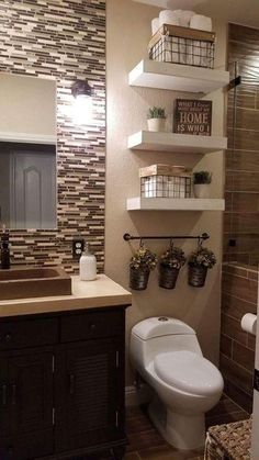 a bathroom with shelves above the toilet and sink