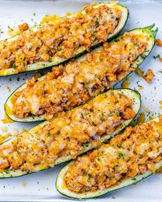 stuffed zucchini boats on a baking sheet with parmesan cheese and seasoning