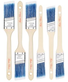 four paint brushes with white bristles and blue bristles