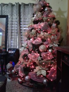 a decorated christmas tree with pink and silver ornaments