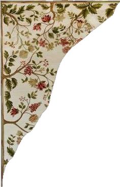 the corner of a wall hanging with flowers and leaves painted on it's side