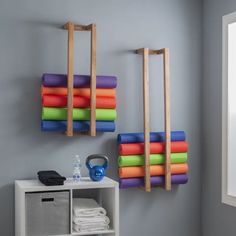 there are several yoga mats hanging on the wall in this room, and one is made out of wood