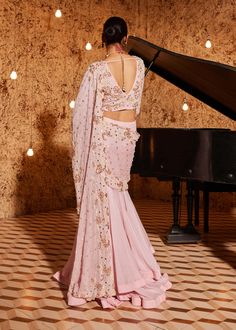 Step into elegance with this gorgeous strawberry pink drape sari in foil georgette, featuring exquisite embroidery detailing on the palla and blouse. The ensemble is paired with a pink on pink fully embroidered flattering v-neckline full sleeves blouse. Ensuring a perfect fit, the blouse is padded and equipped with a hook-eye closure on the back, adding a touch of sophistication to this stunning outfit. Drape Sari, Full Sleeves Blouse, Pink Sari, Full Sleeve Blouse, Strawberry Pink, Drape Saree, Embroidery Detailing, Indian Wedding Wear, Sleeves Blouse