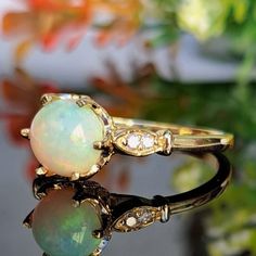 1.25 Carat Natural Opal & Diamonds 14k Solid Gold Ring Ring Material: 14k Solid Gold Total Metal Weight: 2.8 Grams Gemstone: Natural Opal Gemstone Color: Multicolor Gemstone Shape: Round Cabochon Gemstone Dimensions: 7.00x7.00 mm Gemstone Quantity: 1 Gemstone Carat Weight: 1.15 Carat Diamonds: Natural Round Shaped Diamonds Quantity: 4 Diamonds Total Carat Weight: 0.10 Carat Total Carat Weight: 1.25 Carat Ring Quantity: One Ring Condition: New Made in the USA Delivered in an elegant gift box Plea Solid Gold Ring, One Ring, Yellow Gold Ring, Natural Opal, Ring Ring, Birthstone Ring, Elegant Jewelry, Opal Gemstone, Opal Rings