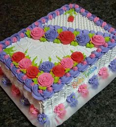 a cake with flowers on it sitting on a table