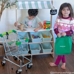 CLASSIC FARMER'S MARKET STAND: Your little one can now engage in constructive and creative play where they imagine themselves as a shopkeeper or browsing fresh produce to bring home! INCLUDES: This set comes complete with 6 plastic storage bins that can be used for pretend fruits & veggies, as well as any other toys that need organizing. A cash register tablet & reversible sign are also included for a more complete play experience. ENCOURAGES CREATIVE PLAY: This pretend play farmer's market stan Farmers Market Stand, Market Stands, Play Kitchens, Kids Play Kitchen, Kids Pretend Play, Playroom Ideas, Plastic Storage Bins, Cash Register, Kids Games