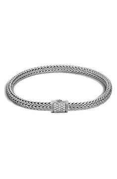 A pavé-diamond clasp adds refined sparkle to an intricately woven silver bracelet alight with pavé-set diamonds. 7" length; 1/4" width Push-clasp closure Total diamond weight: 0.18ct. Color: G-H Clarity: SI Handcrafted Sterling silver/diamond Imported Classic Formal Bracelet With Pave Setting, Classic Formal Chain Bracelet With Pave Setting, Classic Diamond Chain Bracelet With Pave Setting, Classic Diamond Bracelet With Sterling Silver Clasp, Classic Silver Chain Bracelet With Pave Setting, Bracelet In Silver, John Hardy, Silver Diamonds, Pave Diamonds