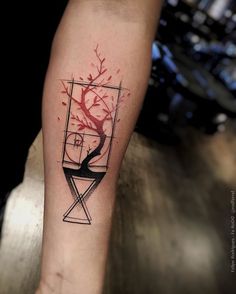 a tattoo on the leg of a person with a tree and geometric shapes in it