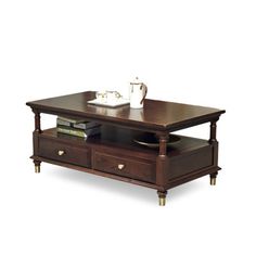 a coffee table with two drawers and a cup on it's top, in front of a white background