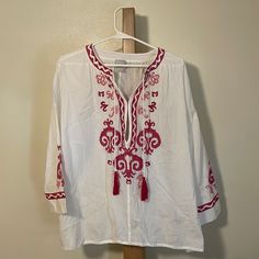 Chico’s Embroidered Blouse With Tassels, Hook And Eye Closures, And Scalloped Hem. New Without Tags! Long Sleeve Tassel Tops For Vacation, Long Sleeve Blouse With Embroidered Hem For Beach, Long Sleeve Blouse With Tassels For Beach, Summer V-neck Peasant Top With Tassels, Vacation Peasant Top With Tassel Ties, Vacation Long Sleeve Peasant Top With Tassels, Traditional Spring Blouse With Tassels, Spring Folk Style Tops With Tassels, Long Sleeve Blouse With Embroidered Hem For Vacation