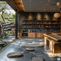 an outdoor kitchen with stone flooring and wooden shelves filled with pots and pans