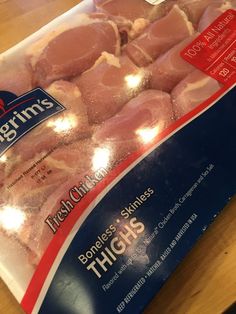 packaged meat sitting on top of a wooden table