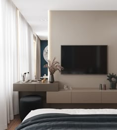 a bedroom with a large flat screen tv mounted to the side of it's wall