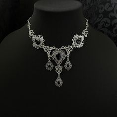 "This romantic necklace features richly detailed antiqued silver filigrees, scrolls and beaded accents. Adorned with sparkling jet black glass crystals, its breath taking design will add Victorian elegance to your outfits. Decorated portion is 8 1/4\" wide and 2 3/4\" tall in the very center.  Necklace length is adjustable with soldered stainless steel cable chain, lobster clasp and extender. If you would like a different length, please send us a message. Matching headpiece and earrings are listed separately in our store. If you don't see items with a color you want, feel free to ask about availability." Silver Gothic Jewelry For Jewelry Making, Ornate Black Filigree Jewelry, Ornate Black Necklace For Formal Occasions, Ornate Black Jewelry With Intricate Design, Gothic Metal Jewelry With Filigree, Black Metal Necklaces For Wedding, Gothic Filigree Metal Jewelry, Elegant Black Metal Necklace For Weddings, Black Wedding Jewelry With Intricate Design