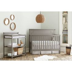 a baby's room with a crib, changing table and bookshelf