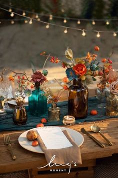 the table is set with flowers, candles and napkins for dinner guests to enjoy