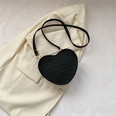 Introducing our Heart Shaped Shoulder Bag, a delightful and unique fashion accessory that adds a touch of romance to your look. Crafted from a special material that's incredibly soft to the touch, it offers a luxurious feeling you'll love. Available in a stunning array of seven different colors, this heart-shaped bag is perfect for expressing your individual style and adding a playful twist to any outfit.