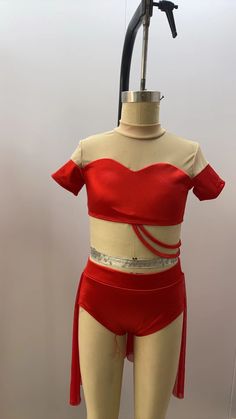 a mannequin wearing a red top and skirt