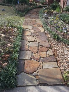 a stone path in front of a house