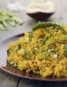 a plate filled with rice and vegetables on top of a wooden table