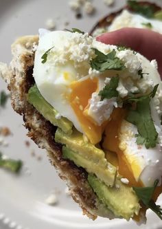 an egg and avocado sandwich on toasted bread with sour cream, mayonnaise, and cilantro