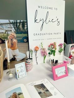 there is a sign that says welcome to kyllie's graduation party on the table