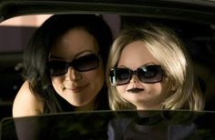 two women wearing sunglasses are sitting in a car