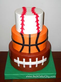 a three tiered cake made to look like a basketball and football ball on top