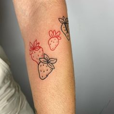 a person with a tattoo on their arm that has strawberries and strawberrys on it