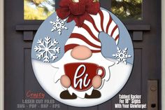 a christmas door hanger with the letter h on it and a santa clause holding a coffee cup