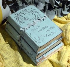 a stack of books sitting on top of a yellow blanket