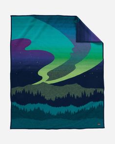 a blanket with an image of the northern lights in green, purple and blue colors