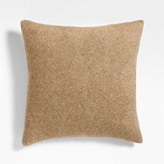 a brown pillow on a white wall