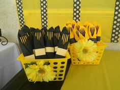 yellow and black plastic flowers in baskets on a table with polka dot tables cloths