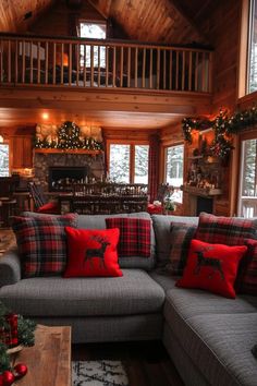 the living room is decorated for christmas with red and black plaid pillows on the couch