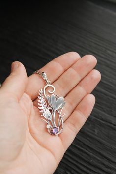 ITEM DESCRIPTION: The size H 5 cm x W 3 cm (2 x 1 inch). Weight - 4 g. You can buy it with a silver chain or without it. I made this unique Crocus pendant of sterling silver, dark amethyst, and moonstone. This is similar to the first spring flowers that appear from under the snow. The floral necklace looks so gentle and elegant! This handmade necklace will come to you in a gift box - ready for gifting. The parcel will be sent 1-2 days after payment. Delivery usually takes 10-21 days. But in the Elegant Flower Shaped Large Pendant Jewelry, Elegant Flower-shaped Large Pendant Jewelry, Elegant Floral Large Pendant Jewelry, Flower Pendant Metal Jewelry As Gift, Flower Pendant Metal Jewelry Gift, Metal Flower Pendant Jewelry As Gift, Metal Flower Pendant Jewelry For Gifts, Unique Flower Pendant Necklaces With Charm, Silver Nature-inspired Necklace With Flower Charm