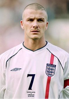 a man with a bald head wearing a soccer uniform