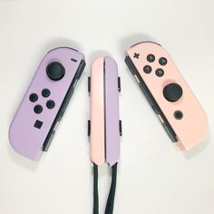 three nintendo wii controllers sitting next to each other on top of a white countertop