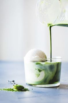 a green smoothie with ice cream and a sprig of mint on top