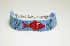 a beaded bracelet with a fish design on it's front and back sides