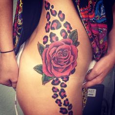 a woman's stomach with a rose and leopard print on it